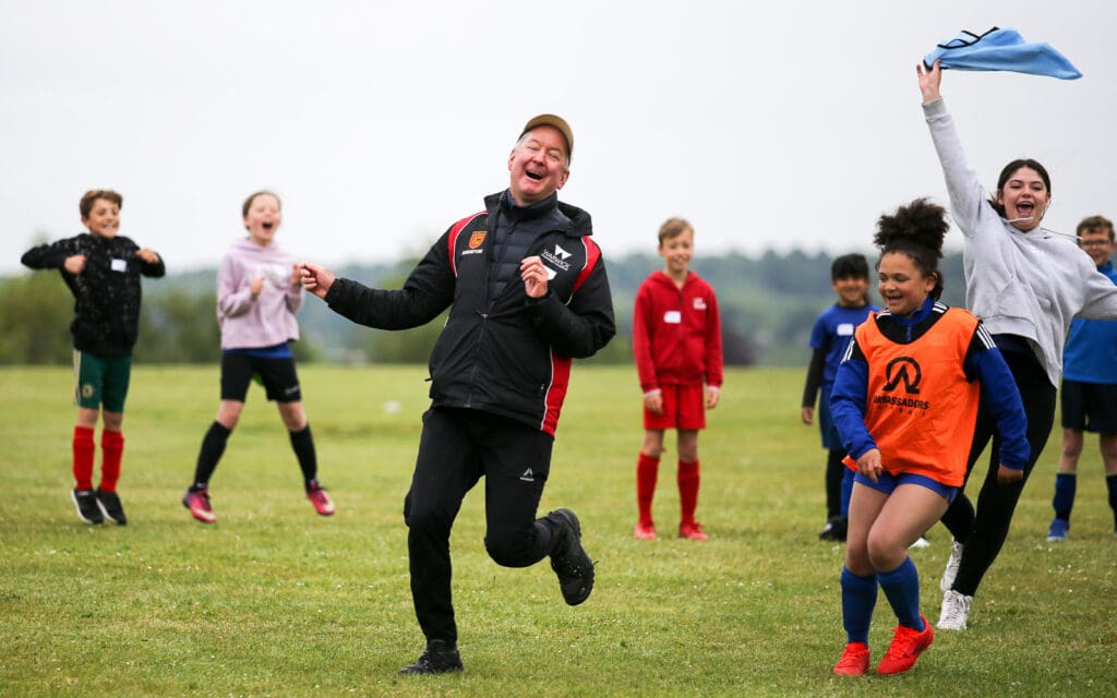 af gb-kids having fun chasing their coach