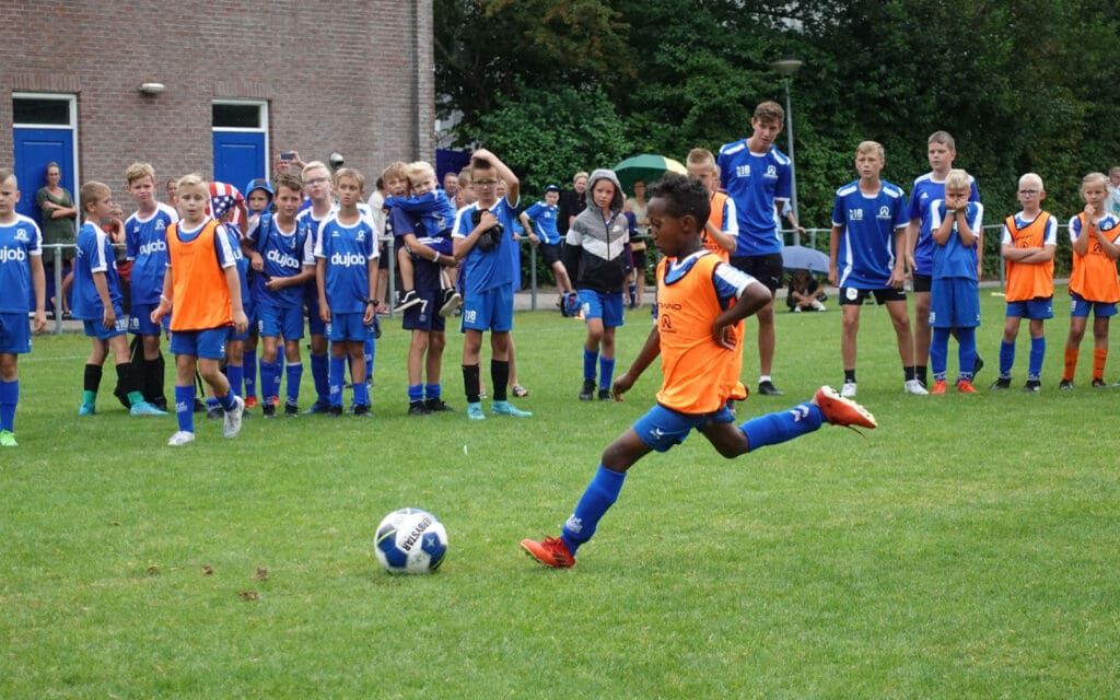 af netherlands-kid kicking a soccer ball