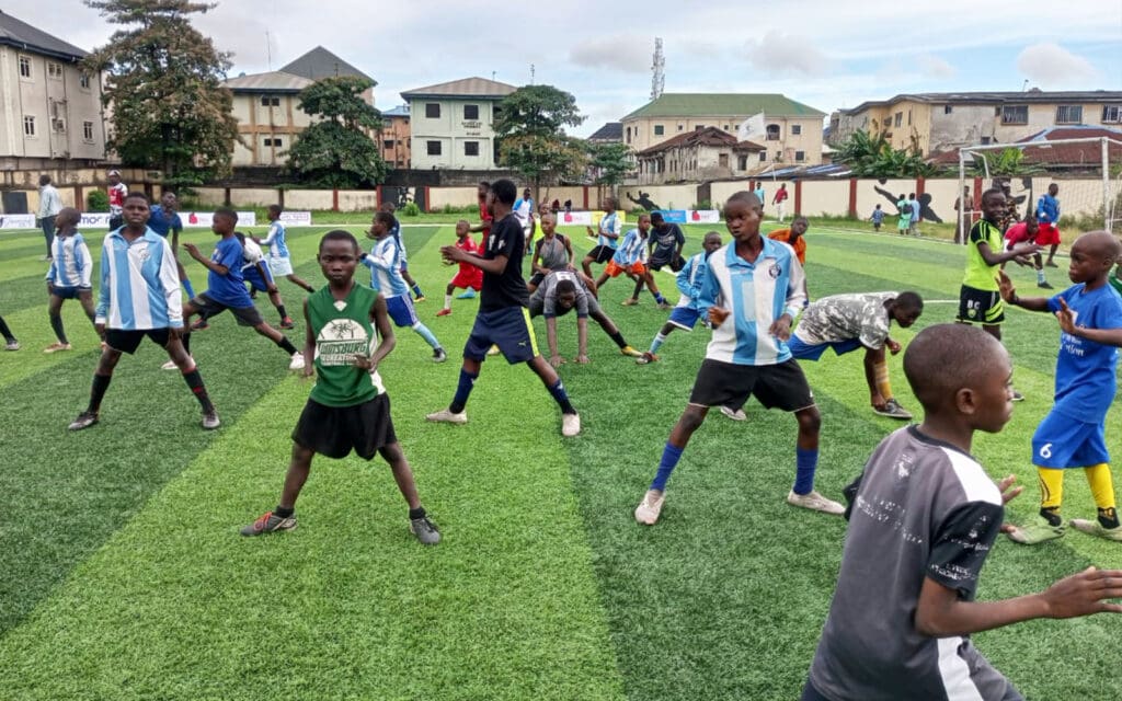 af nigeria-kids stretching and getting ready for football practice