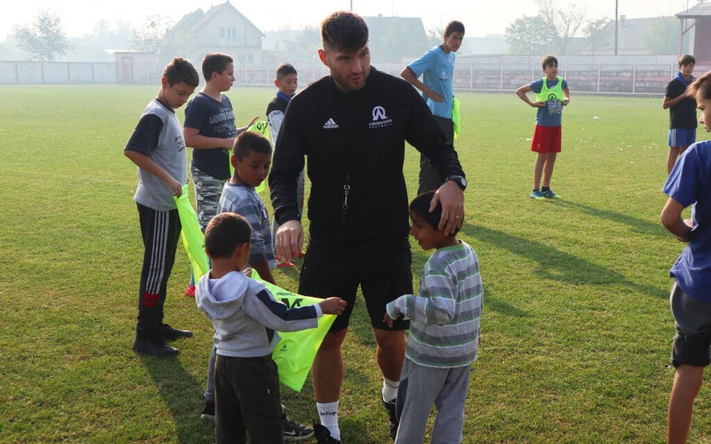 af serbia-coach teaching football to youth