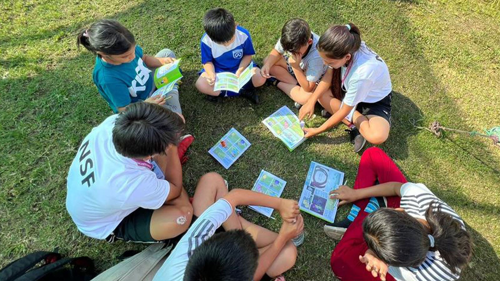 kids reading through a Toward the Goal booklet-v3