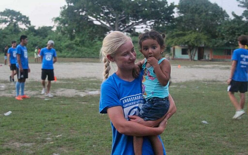 female-coach-holding-a-young-girl-during-a-soccer-camp-in-colombia.jpg