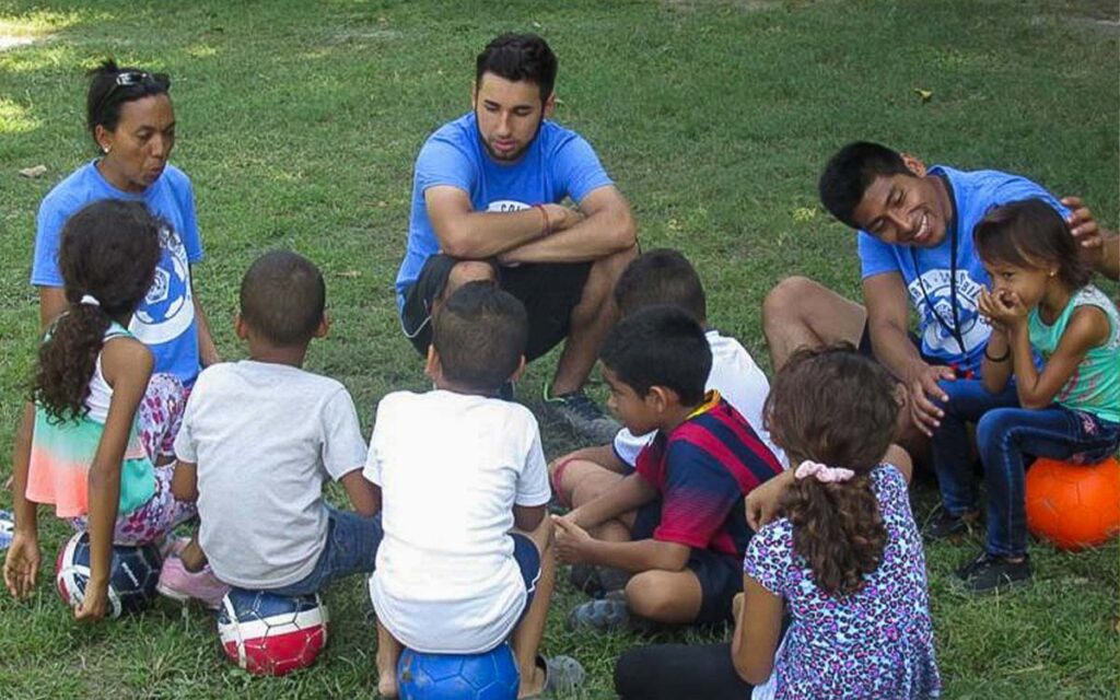 young-coaches-teaching-kids-at-soccer-camp-in-colombia.jpg