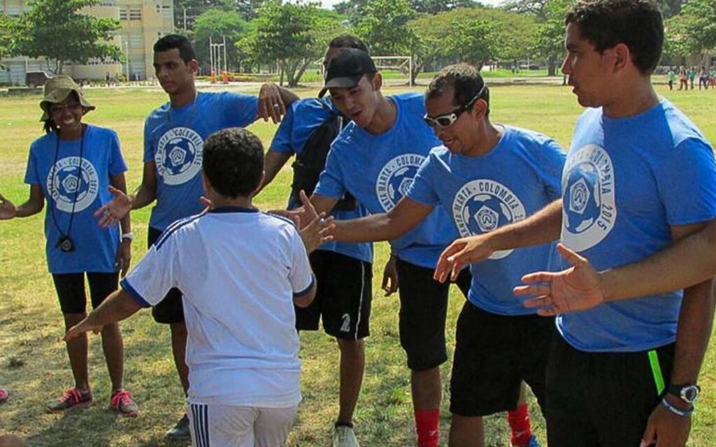 young-soccer-coaches-in-colombia-high-fiving-a-kid-at-soccer-camp.jpg