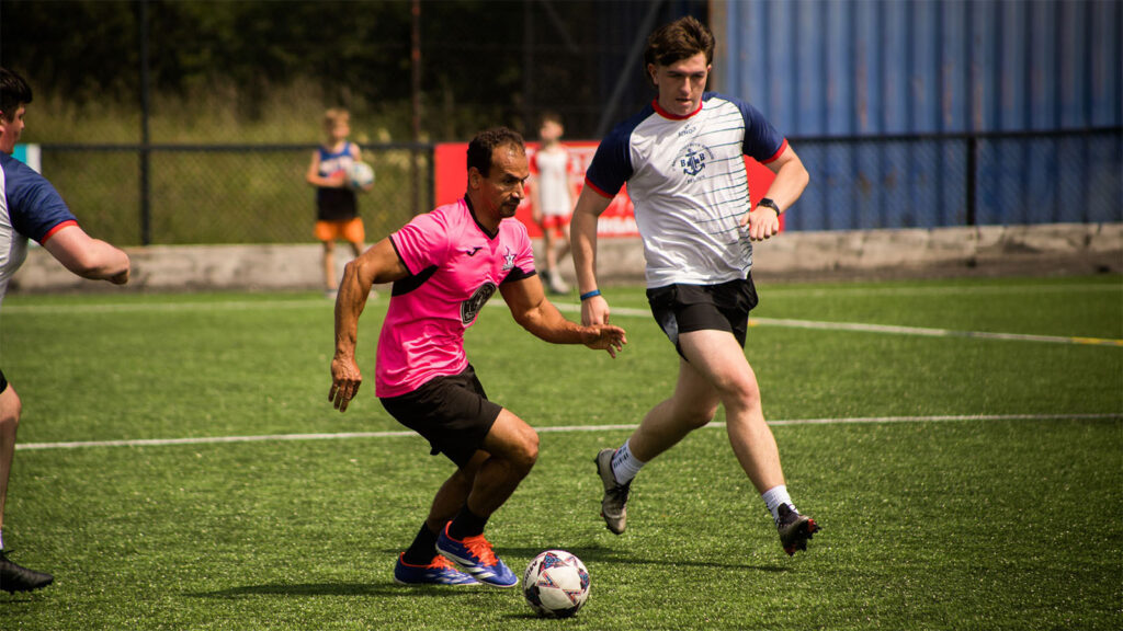 players running for the football at a ni churches cup tournament