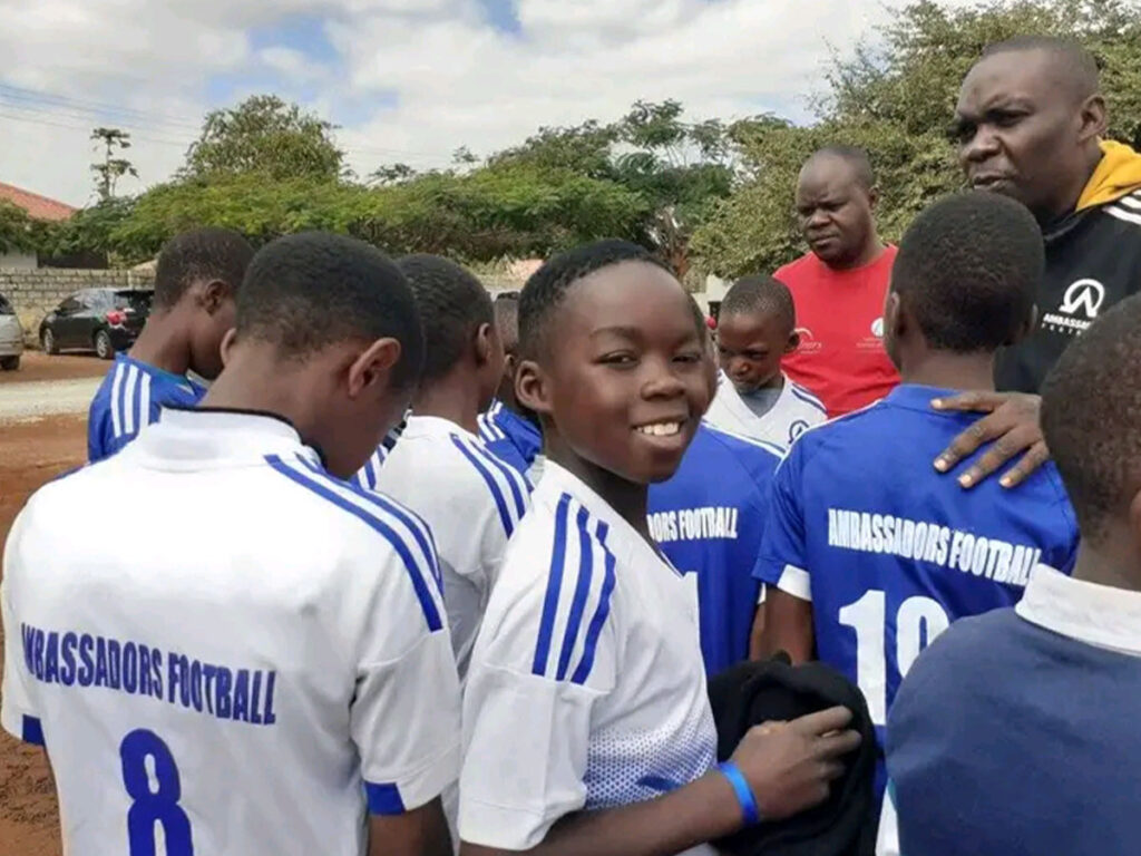 group-of-players-huddled-together-at-Ambassadors-Football-Zambia.jpg