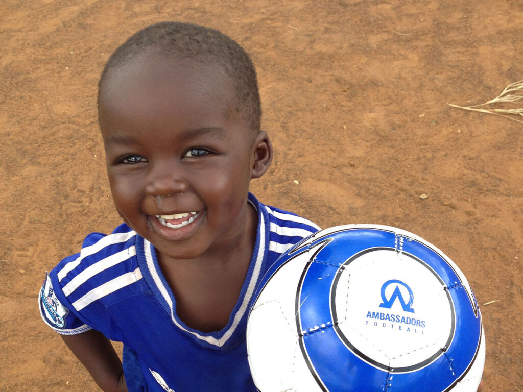 kid-holding-football-at-football-camp.jpg