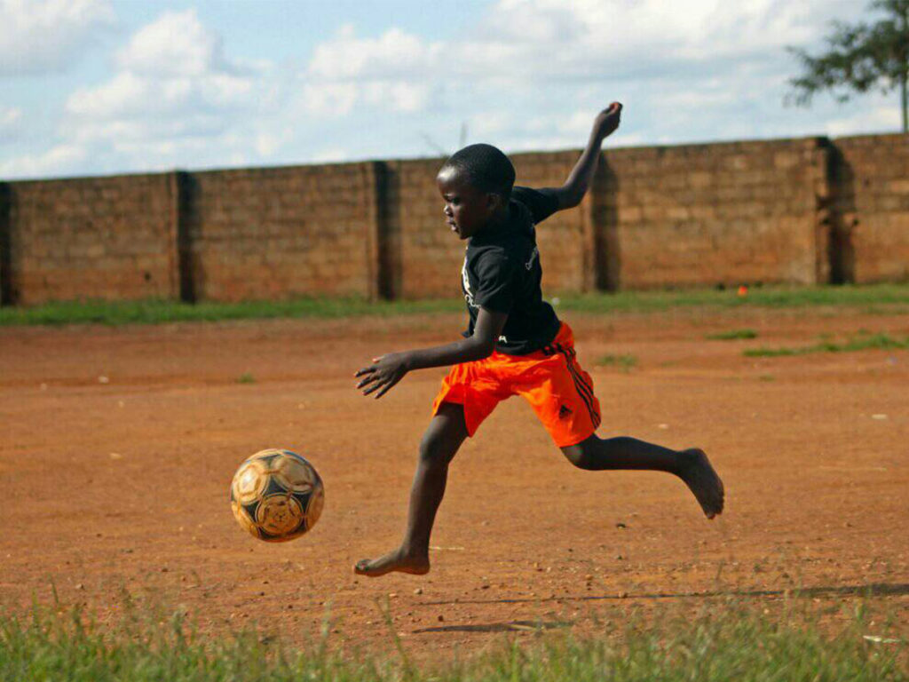 kid-kicking-football-at-Ambassadors-Football-Zambia.jpg